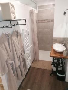 a bathroom with a shower and a sink and towels at La parenthèse in Béthisy-Saint-Pierre +8 photos