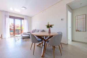 a dining room with a table and chairs at Serene Escape Near the Sea - Pool &Private Parking in Los Alcázares +23 photos