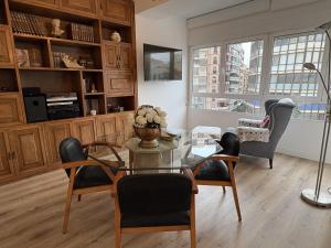 a living room with a glass table and chairs at Lujo alfonso el sabio in Alicante