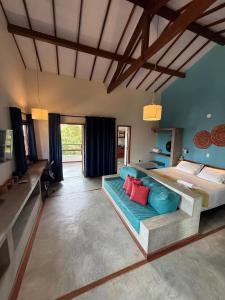 a large bedroom with a bed and a couch at Flat amplo a 50m da praia em Barra Grande in Barra Grande