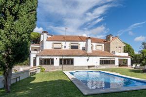 a large house with a swimming pool in front of it at Apartoyou - Finca Privada in El Puerto de Santa María