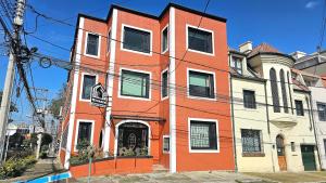 an orange and white building on a city street at Hotel Ktaleya Apartamentos in Bogotá