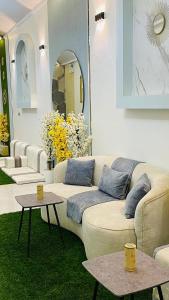 a living room with a couch and two tables at SAMA ALWADi in Wadi Al Dawasir