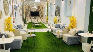 a living room with couches and tables and a tv at SAMA ALWADi in Wadi Al Dawasir