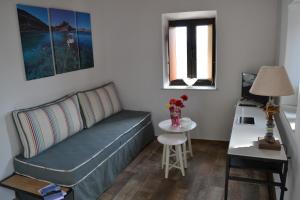 a living room with a couch and a table at CasaLindos Spitaki in Lindos