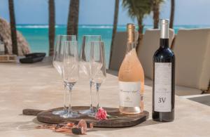 a table with two bottles of wine and three wine glasses at Tankah Bay 56 in Balcheil