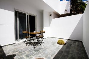 Habitación con balcón con mesa y sillas. en The Inn, en Corralejo