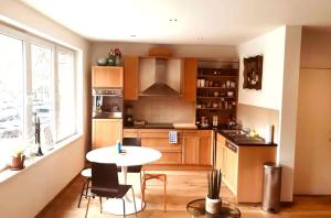 a kitchen with a table and a small table with chairs at Stylish & Spacious Flat viewing the Lovely MAS in Antwerp