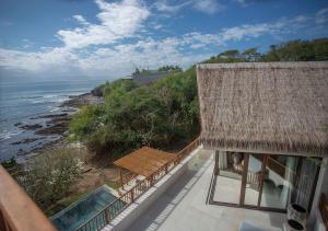a building with a view of the ocean from a balcony at Casa Coral, Luxury Beachfront in Higuera Blanca