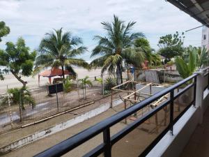 a balcony with a view of a beach and palm trees at RS Hotel Granada in Atacames