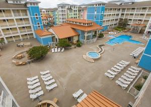 an aerial view of a pool and lounge chairs in a resort at Lazy Waves 414B in Virginia Beach