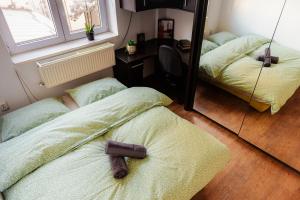 a bedroom with two beds and a mirror at Promenada Old Town Apartments in Bucharest