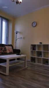 a living room with a couch and a clock on the wall at Cozy Suite #1 in the Heart of DT Quebec with QB in Quebec City