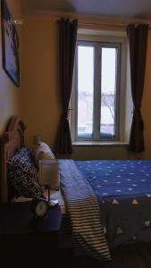 a bedroom with a blue bed and a window at Cozy Suite #1 in the Heart of DT Quebec with QB in Quebec City +1 photo