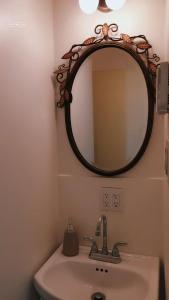 a bathroom with a mirror and a sink at Cozy Suite #1 in the Heart of DT Quebec with QB in Quebec City