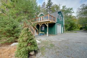 a green house with a deck on top of it at Cozy Apt with Deck, about 5 Miles to Acadia Natl Park! in Northeast Harbor