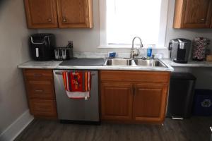 a kitchen with a sink and a stainless steel refrigerator at Werner Haus in Sandusky