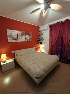 a bedroom with a bed and a ceiling fan at House 39 in Capranica