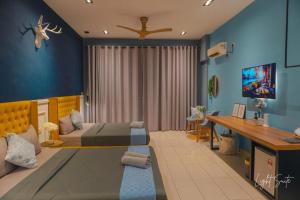 a bedroom with a bed and a desk in it at Cozy Room 5min From Airport Wi-fi & Netflix At Aeropod Sovo in Kota Kinabalu