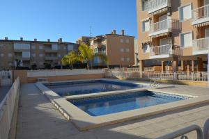 a swimming pool in the middle of a building at Apartment Sol de Santa Pola in Santa Pola