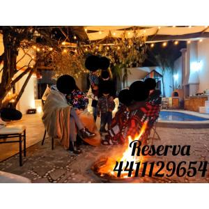 a group of people sitting around a fire at CASA BERNAL PARA FIN DE SEMANA CON ALBERCa in Bernal
