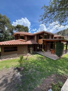 a large house with a patio and a yard at Luxury house in Urubamba, Cusco, Perú in Urubamba +78 photos
