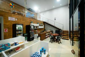 a grocery store with a table and chairs in a room at Pousada Calugy in Jardim