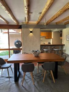 a dining room with a wooden table and chairs at Luxury house in Urubamba, Cusco, Perú in Urubamba