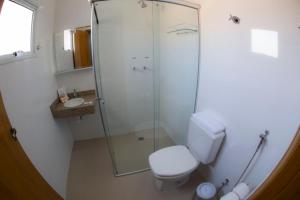 a bathroom with a shower and a toilet and a sink at Hotel San Gennaro in Santa Fé do Sul +84 photos