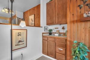 a kitchen with wooden cabinets and a sink at Admiral 3 in Depoe Bay