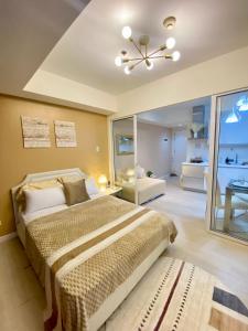 a bedroom with a bed and a ceiling fan at Azure Staycation PH 1503 in Manila +14 photos