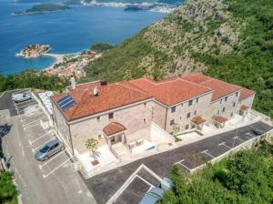 an aerial view of a large house on a hill at Magic view - Apartment with Pool in Budva