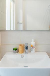 a bathroom sink with a bottle of soap and a coffee maker at Heart of Old Town in Bucharest +42 photos