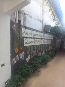 a sign on the side of a building at SUITE CENTRAL BECO DAS FLORES in Jericoacoara +17 photos