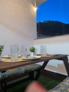 a wooden table with glasses on it in a room at Casa da Serra in Poços de Caldas