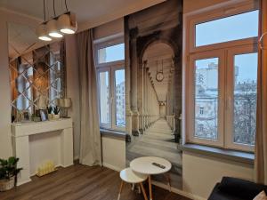 a living room with a view of a building at Polonia Apartments in Łódź
