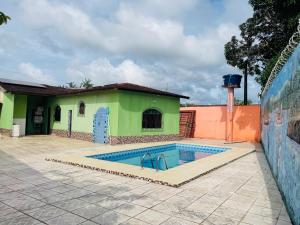 a swimming pool in front of a building at Casa de praia em mmosqueiro para Cop 30 Belém in Belém