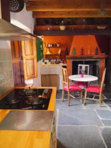 a kitchen with a table and a table and a stove at La Casita de Sandra in Paulenca