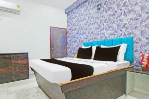 印多尔FabHotel Paradise Inn的卧室里有一张带蓝色床头板的大床