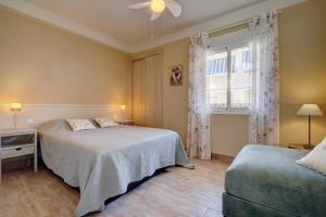 a bedroom with a bed and a window and a couch at Duquesa Marina - Manilva Beach Home in Manilva
