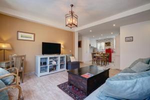 a living room with a couch and a tv at Duquesa Marina - Manilva Beach Home in Manilva