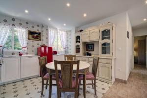 a kitchen with a table and chairs in a room at Duquesa Marina - Manilva Beach Home in Manilva