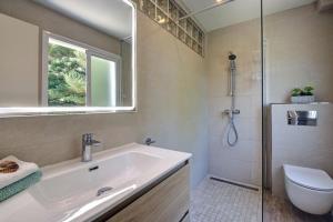 a bathroom with a sink and a shower and a toilet at Duquesa Marina - Manilva Beach Home in Manilva +15 photos