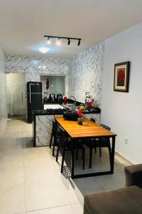 una cucina con un tavolo di legno in una stanza di Casa São Miguel dos Milagres a São Miguel dos Milagres