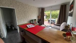 a living room with a table with a red cloth on it at Un cocon de détente entre mer et nature in Zonza