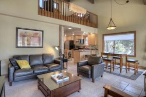 a living room with a couch and a table at Tamarron PineCone 858 in Durango