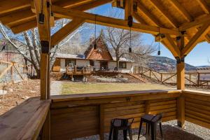 a view from the porch of a wooden pavilion with two chairs at 27405 Highway 550 in Durango
