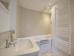 a white bathroom with a sink and a tub at 1 Gabberwell Cottages in Kingston +21 photos