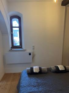 a bedroom with a bed and a window at Haus mit Herz in Sulzbach-Rosenberg