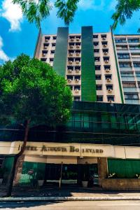 a tallartment building with a tree in front of it at Hotel Augusta Boulevard in Sao Paulo